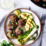 Meatballs with grilled zucchini and grilled onions on a small plate