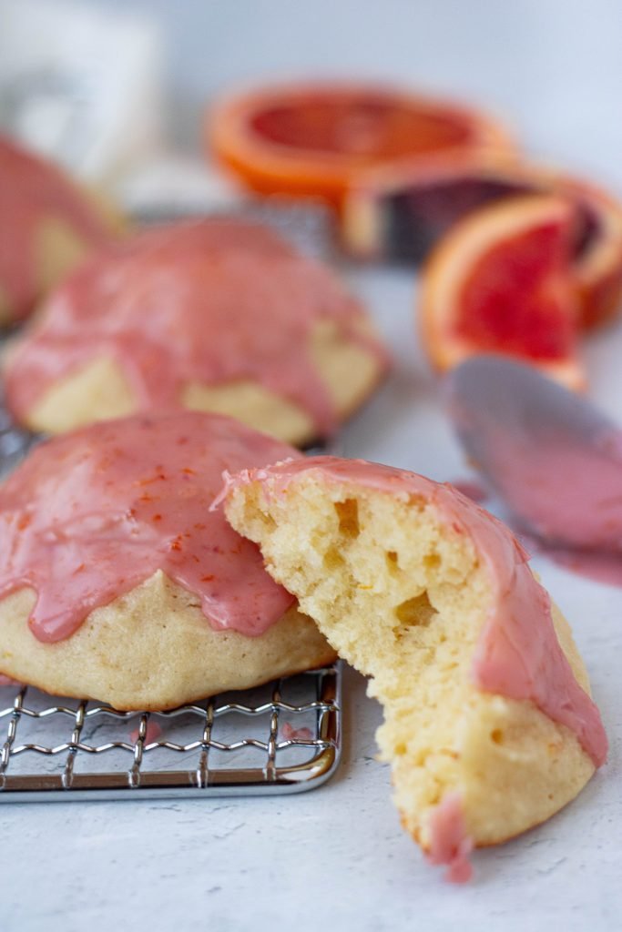 Close up of texture of blood orange ricotta cookie. Pink glaze on top