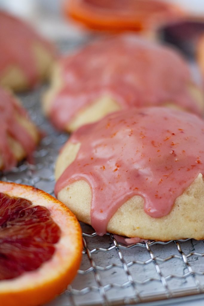 Close up of blood orange ricotta cookie with pink glaze