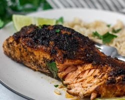 Chili lime salmon on a white plate with rice