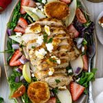 Grilled chicken salad with fried goat cheese, strawberries, pears, and vinaigrette