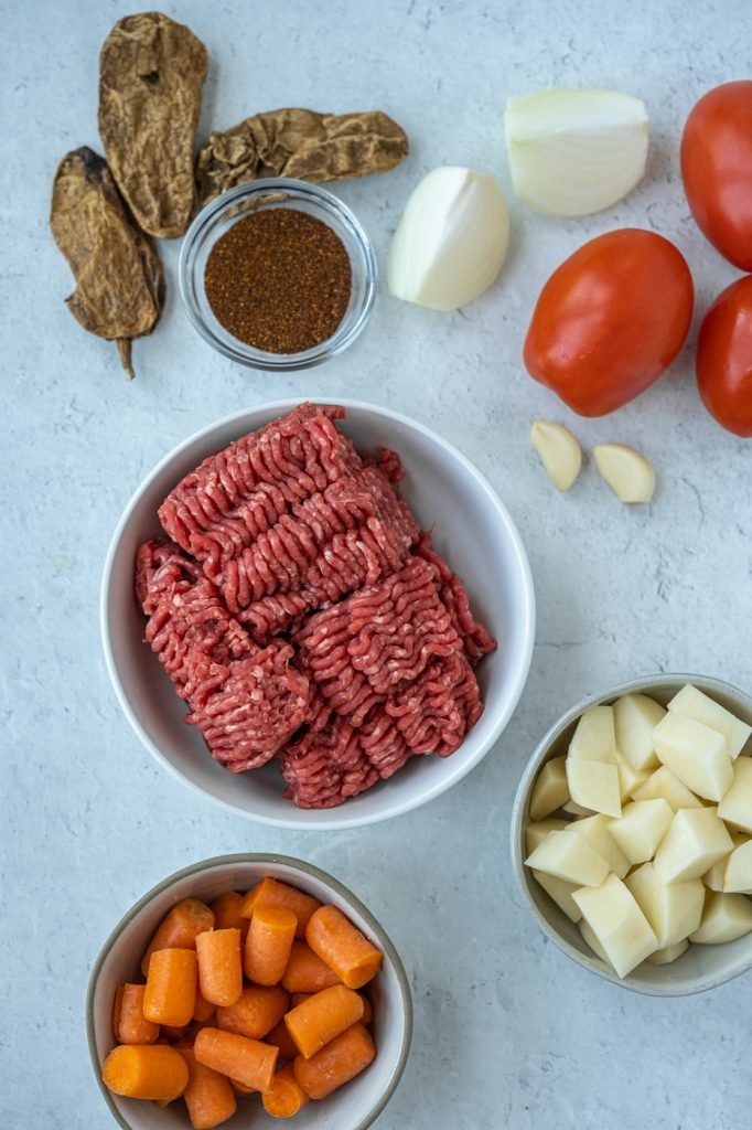 Chipotle pepper, tomatoes, onion, garlic, potatoes, carrots, and ground beef
