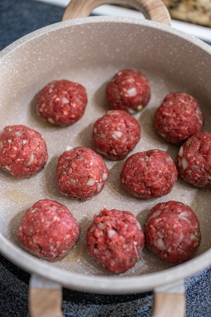 Albondigas (meatballs) cooking in a pan